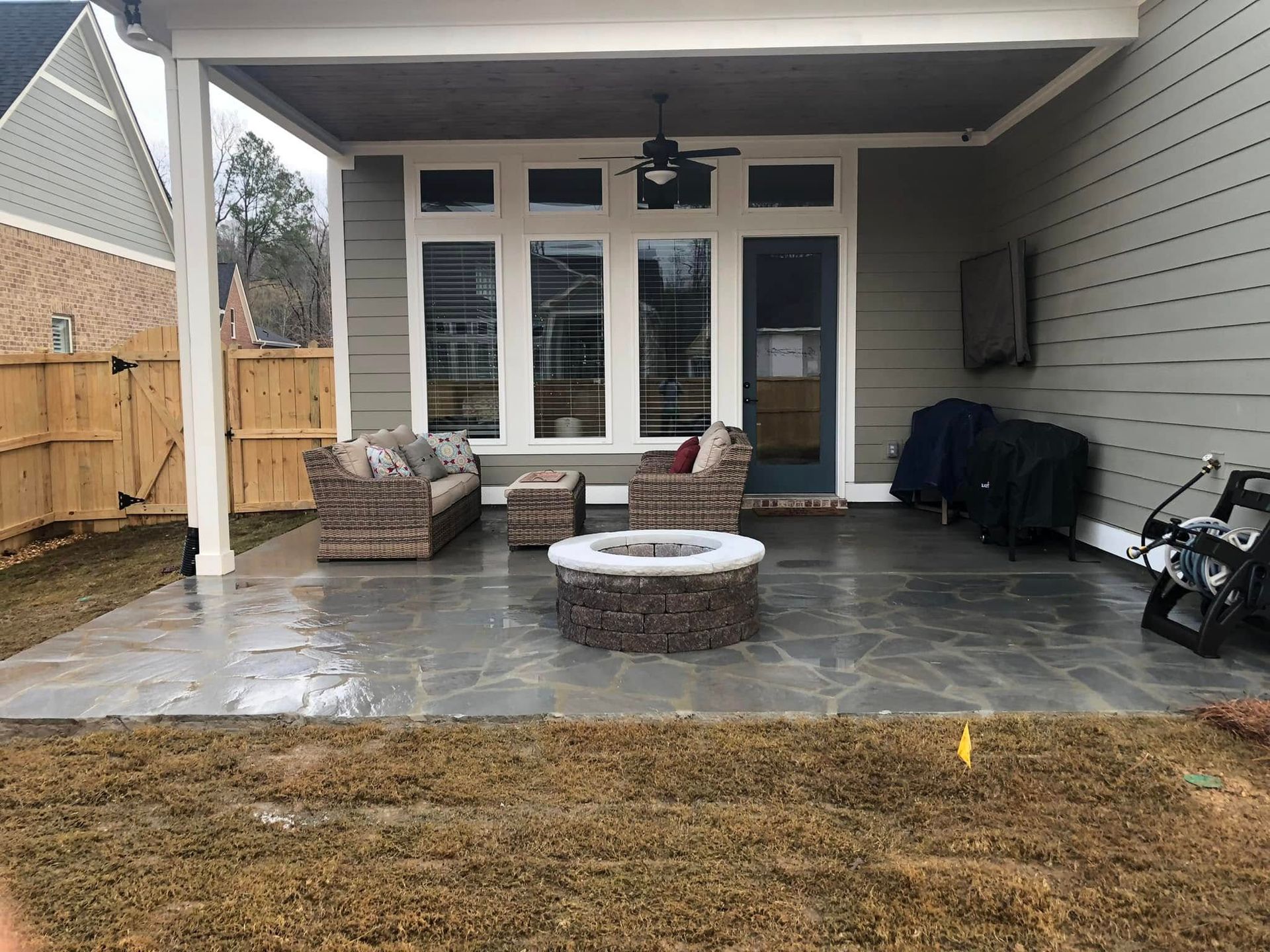 There is a fire pit in the middle of the patio.