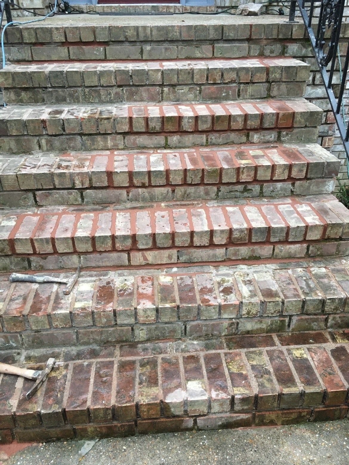 A row of brick stairs leading up to a building.