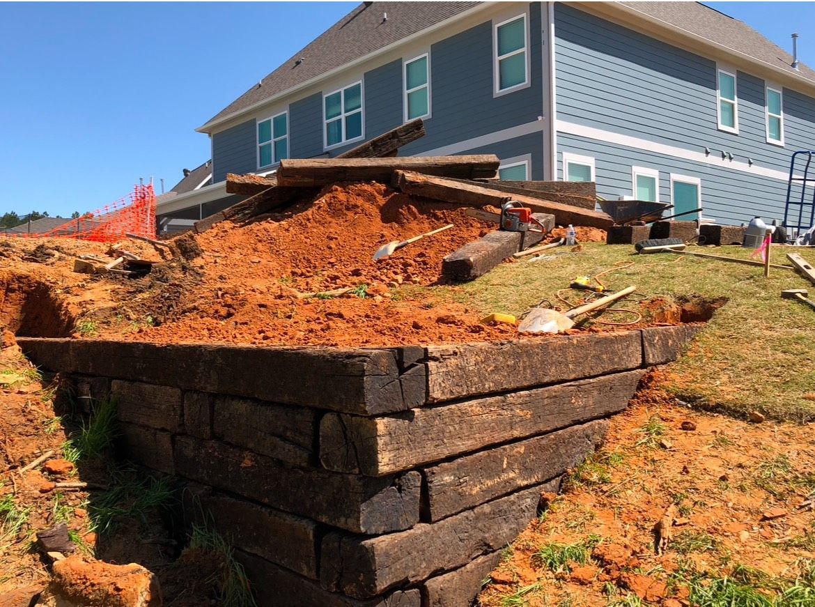 A pile of dirt is sitting in front of a house.