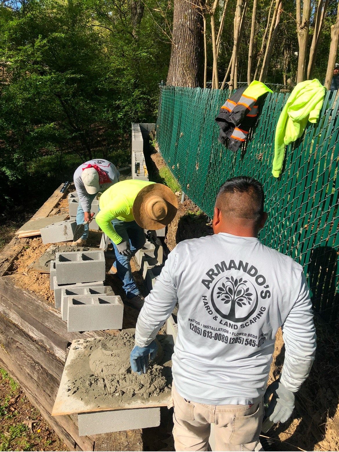 A group of construction workers are working on a concrete project.