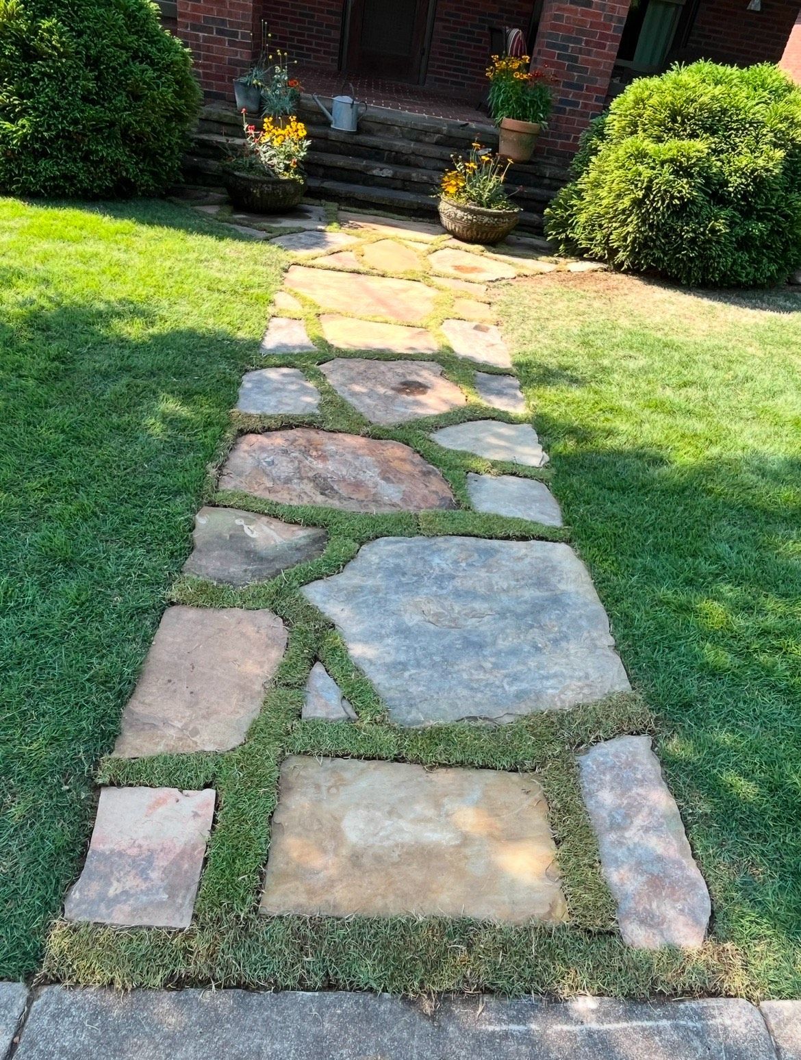 A stone walkway leading to the front door of a house.