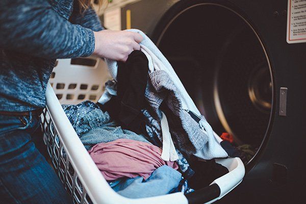 woman retrieving clothes from dryer