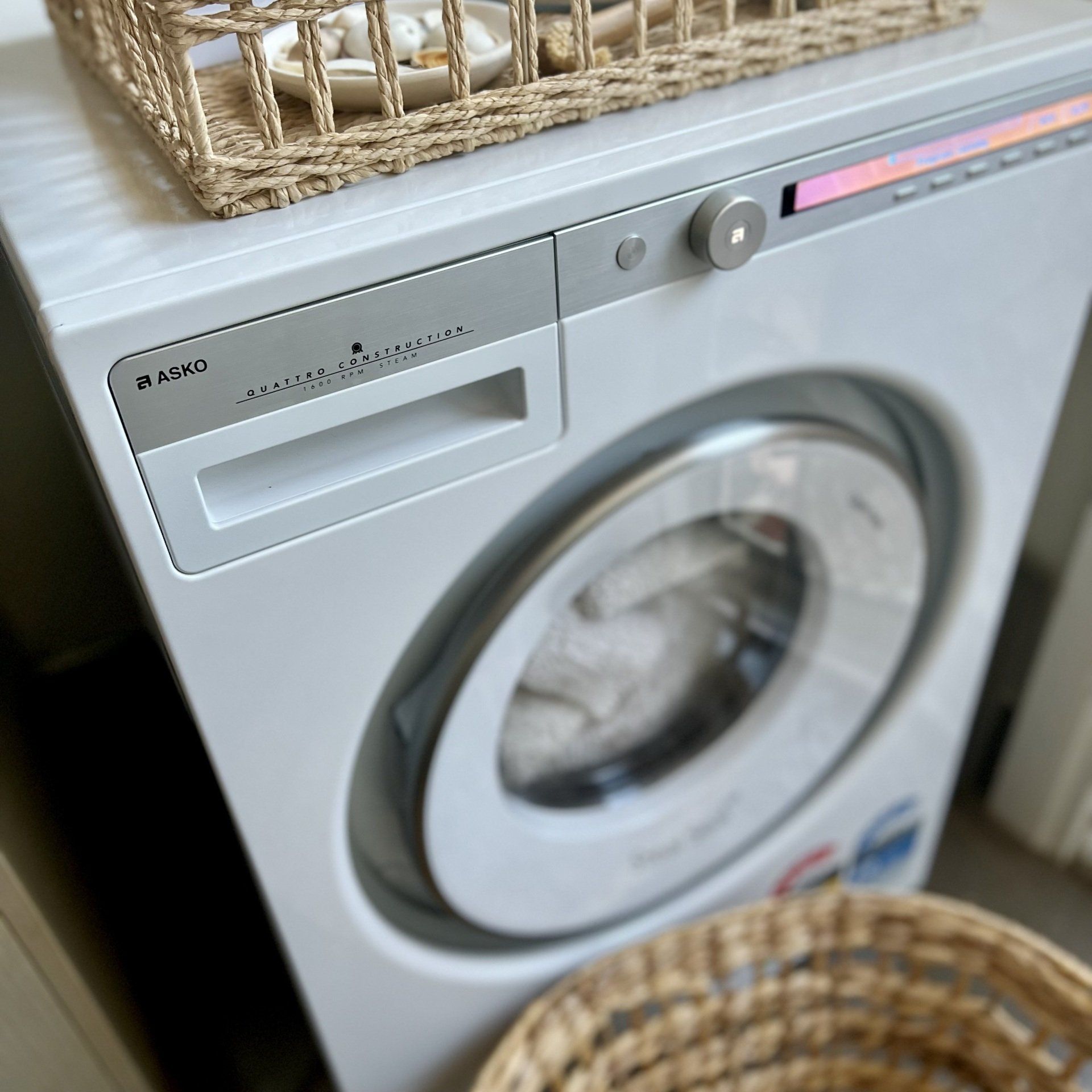 woman retrieving clothing out of washing machine