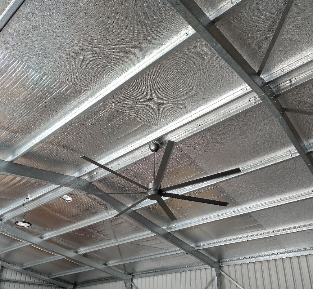 Ceiling Fan in a Warehouse With Clothes Racks and Corrugated Metal Roof — NTR Electrical In Toogoom, QLD