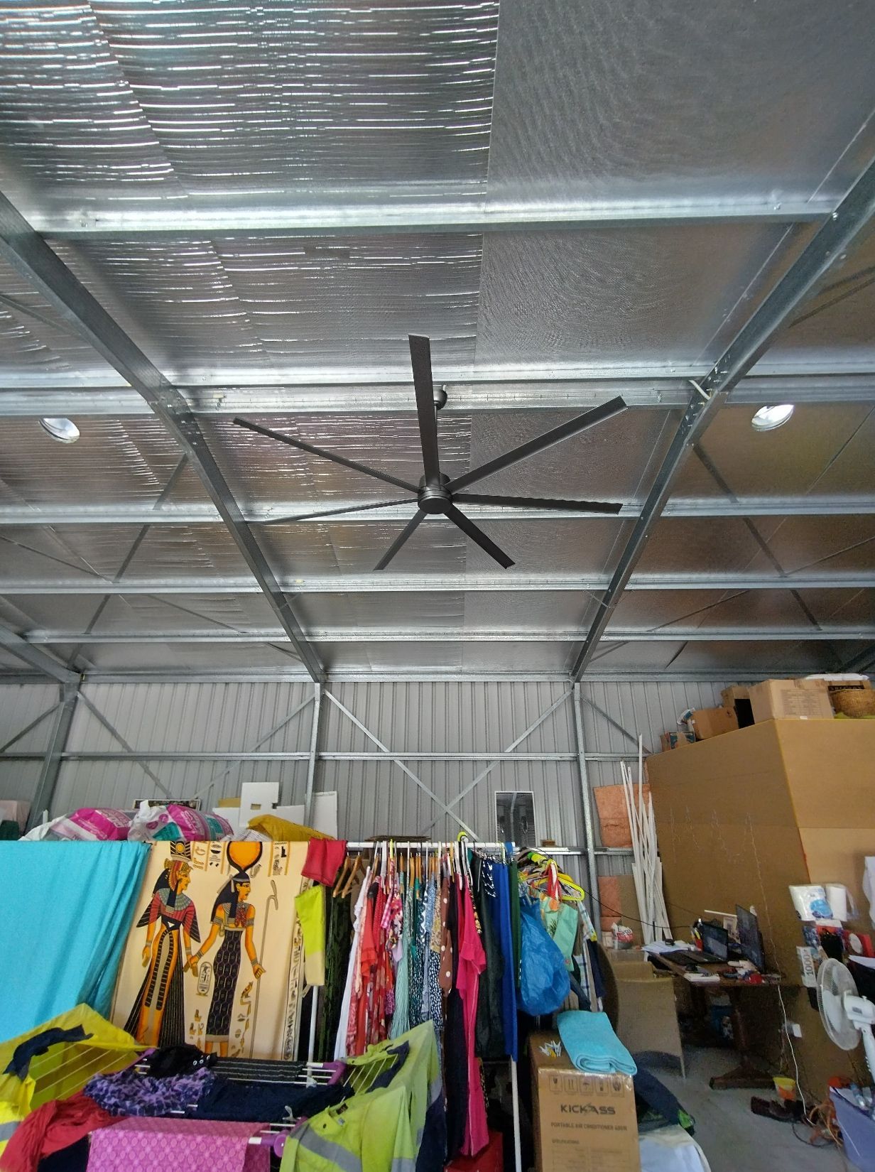 Large Ceiling Fan in a Metal-framed Storage Space, Clothing Racks and Boxes — NTR Electrical In Toogoom, QLD