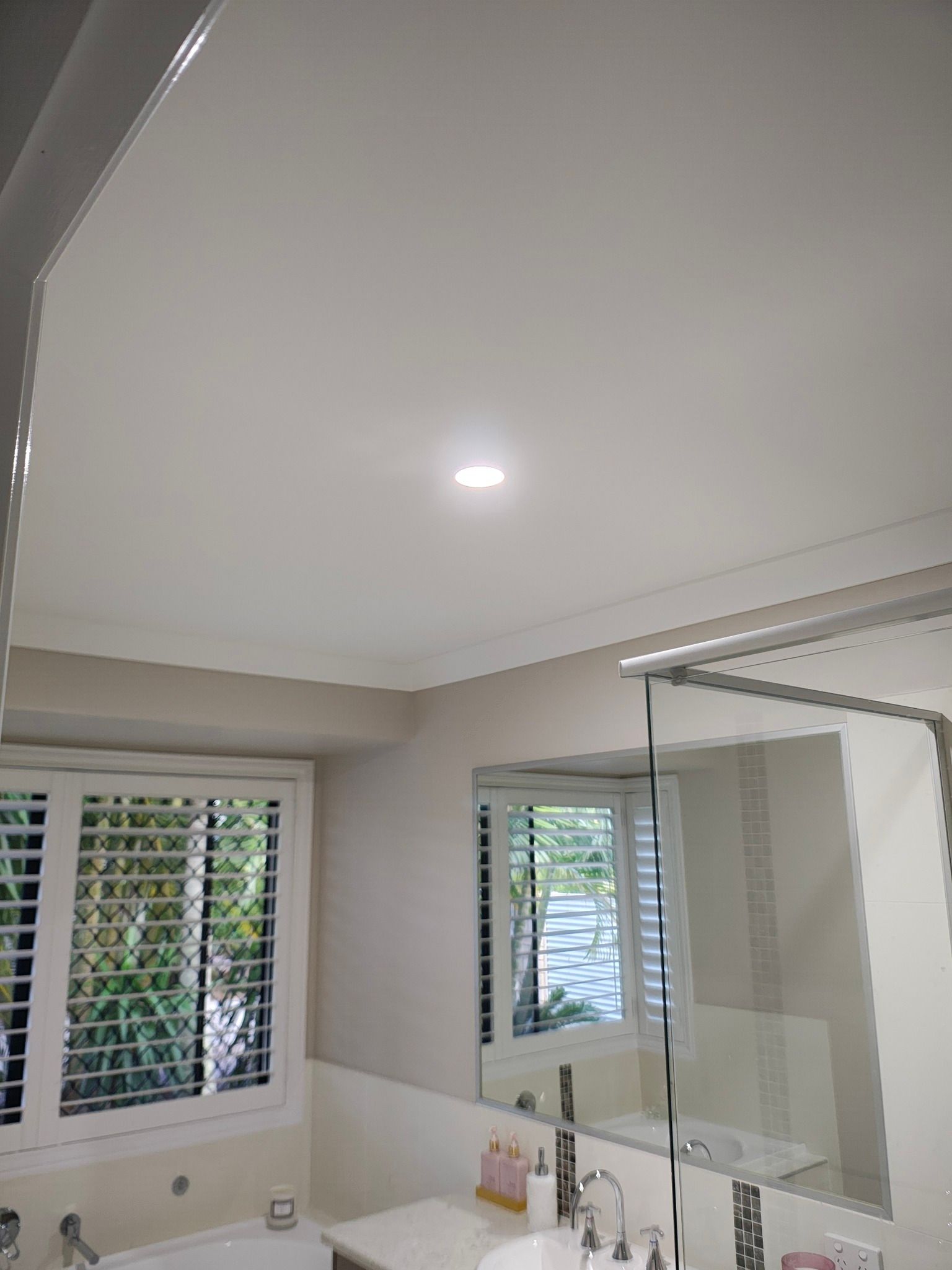 Bathroom Interior With a Window, Vanity, and Overhead Light Centered in the White Ceiling — NTR Electrical In Toogoom, QLD