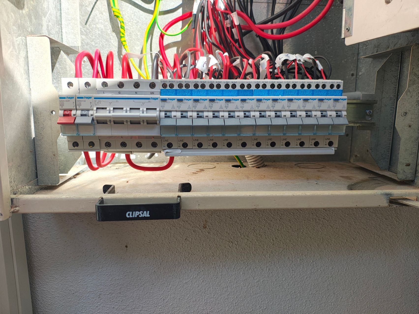 Bedroom With Bed, Window, Nightstands, Dresser, AC, and Wall Sconces — NTR Electrical In Toogoom, QLD