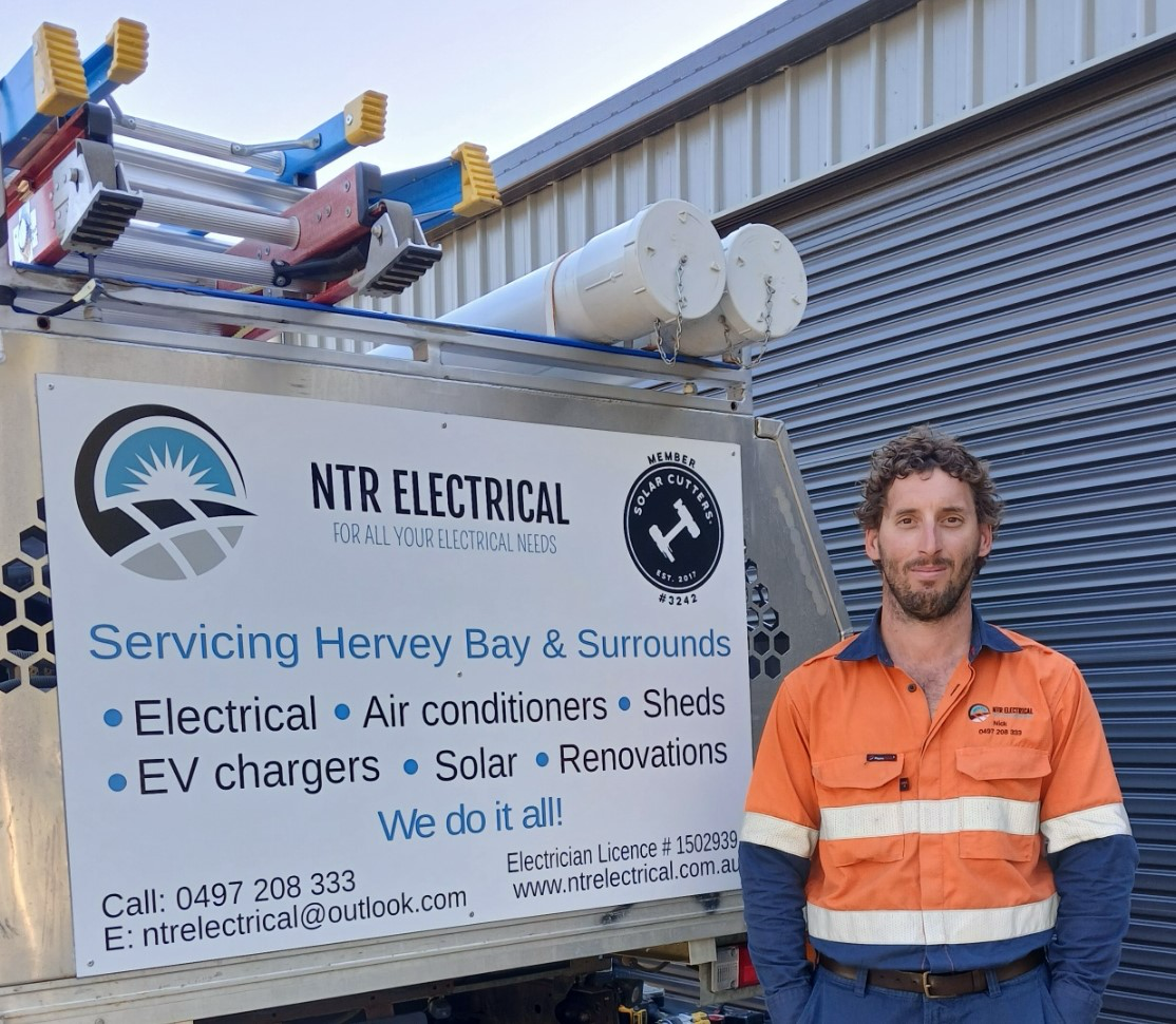A Cluttered Shed Interior With Shelves, Boxes, and Various Items — NTR Electrical In Toogoom, QLD