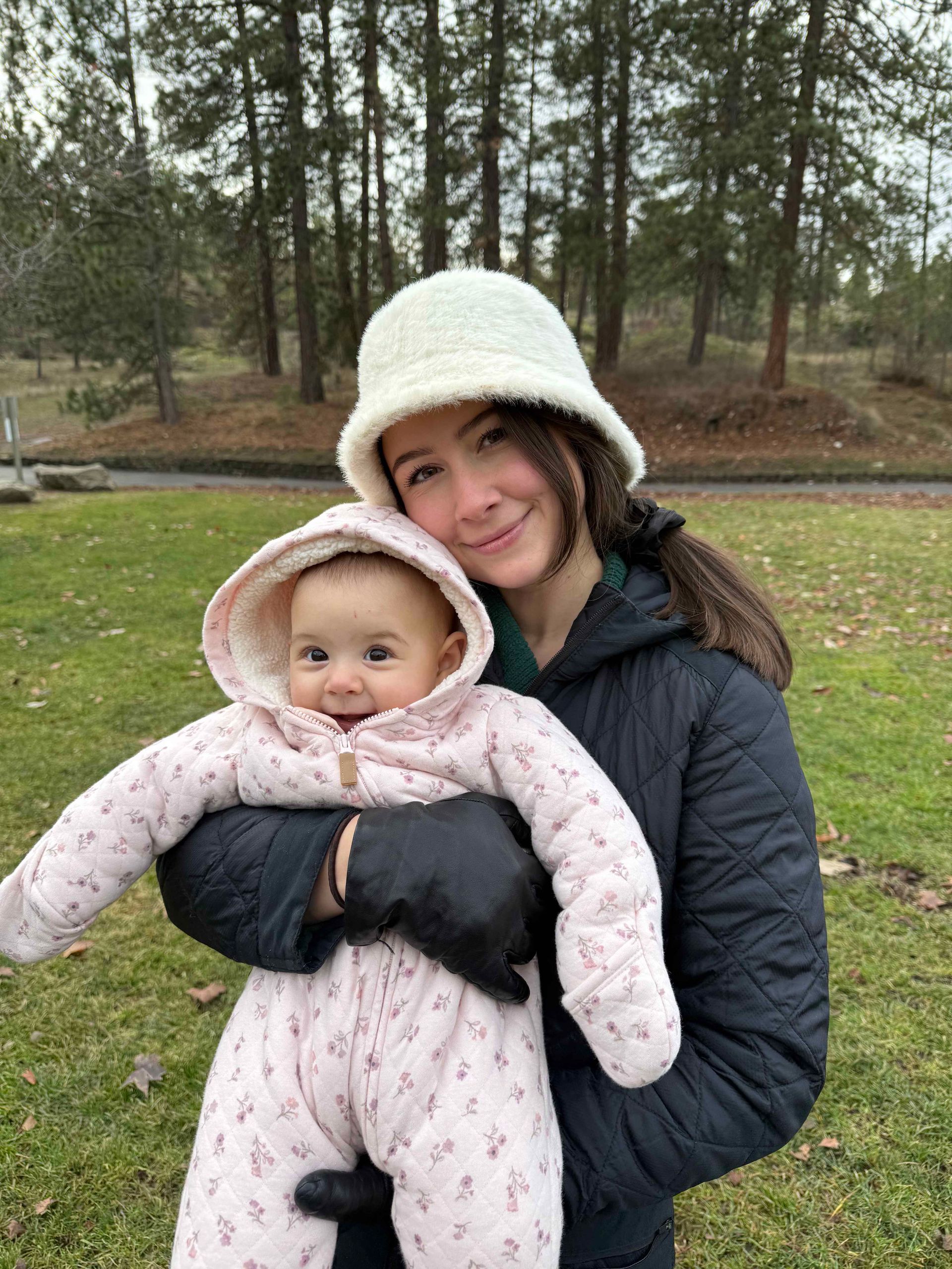 Organix Pest Control's Administrative assistant holding her daughter at a park in Post Falls Idaho.