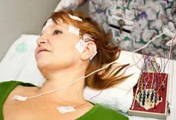 A doctor is talking to a patient while a woman looks at a tablet.