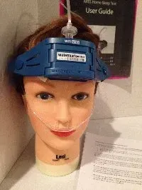 A man is laying in a hospital bed with an oxygen mask on his face.