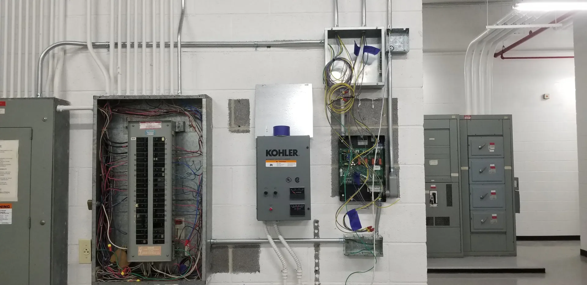 A kohler electrical box is hanging on a wall