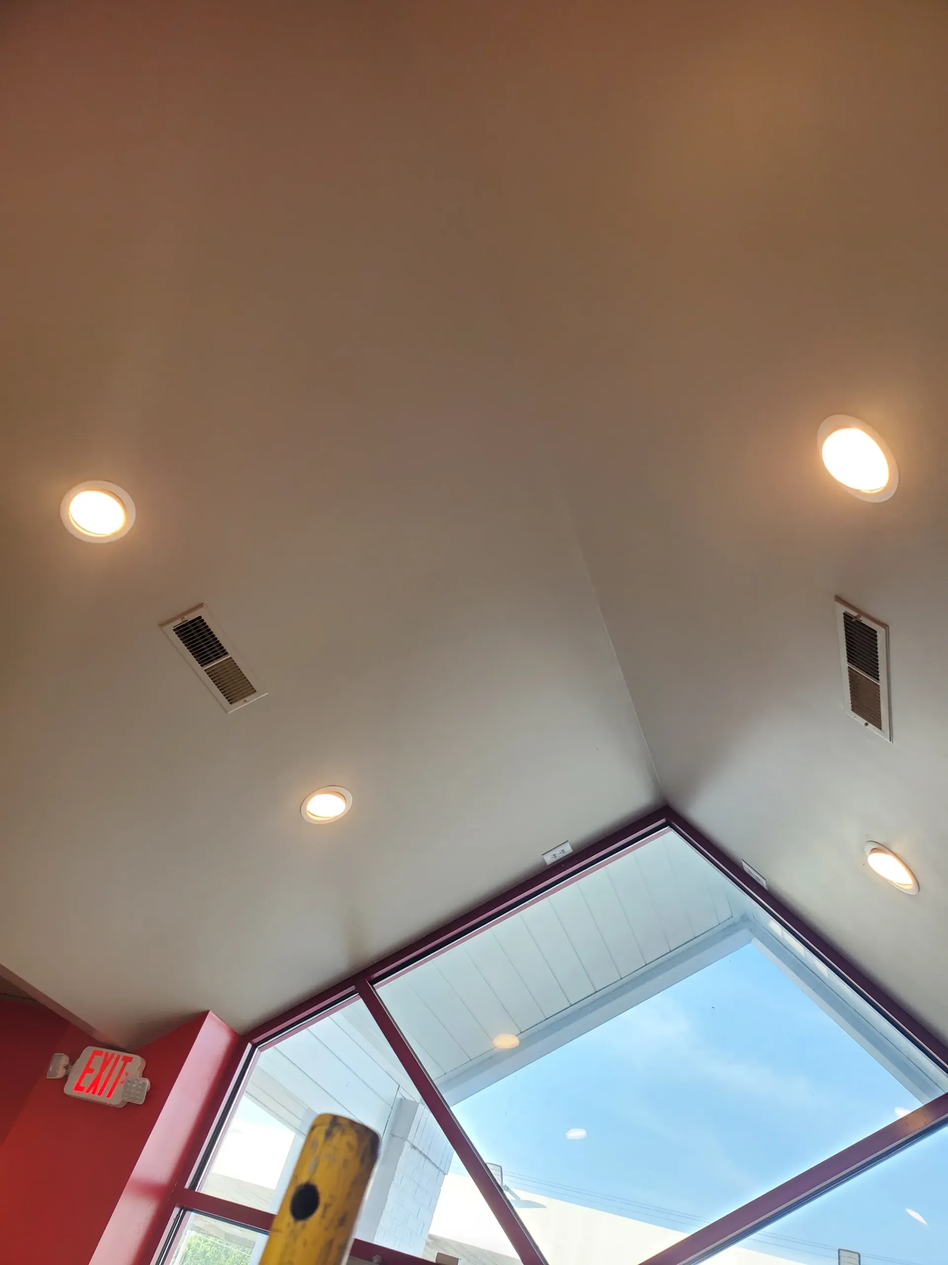 Looking up at the ceiling of a building with a lot of windows.