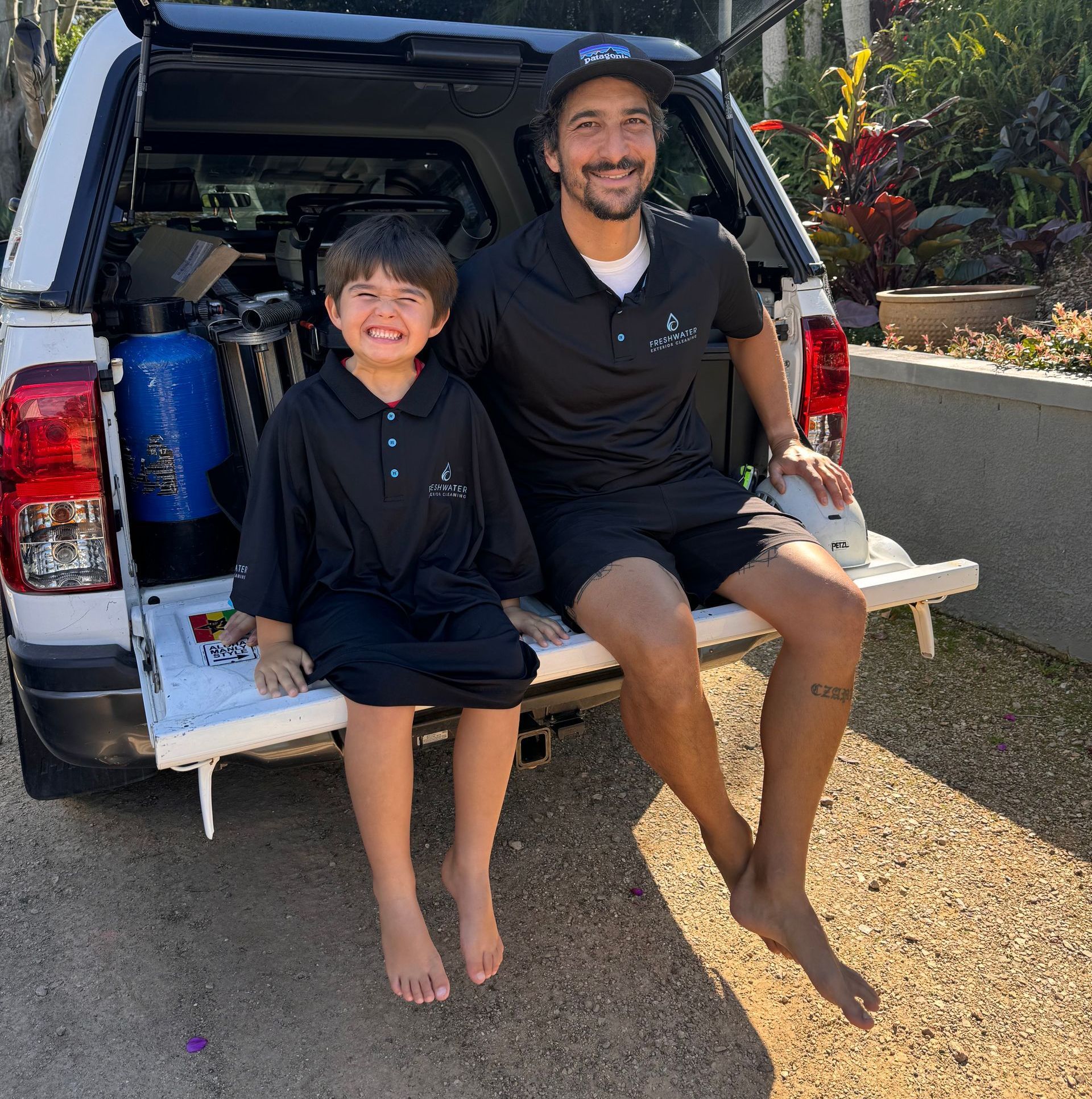 A Man and Son Sitting on the end of a Ute — Freshwater Exterior Cleaning in Ballina, NSW