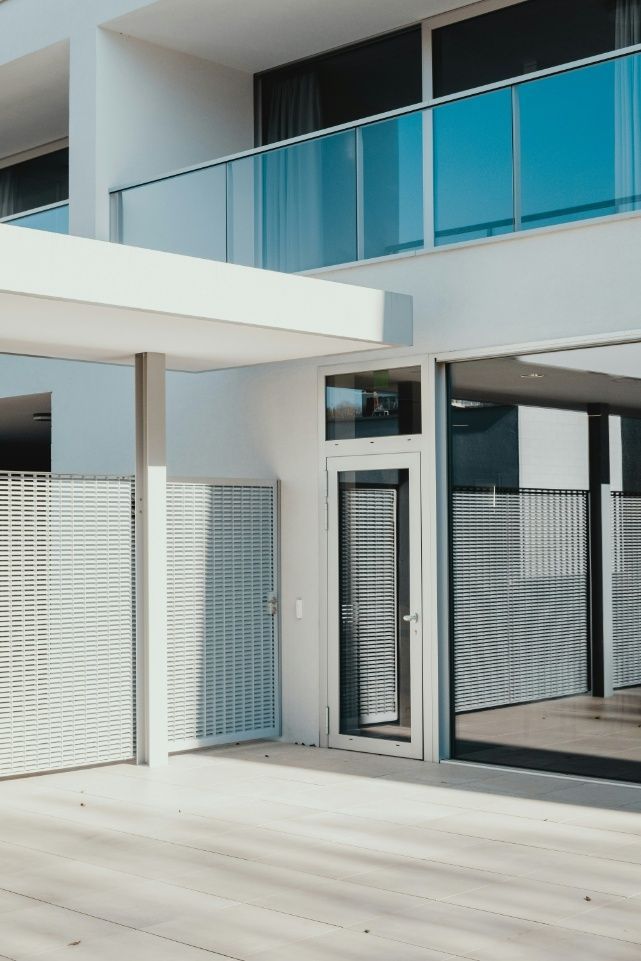 A White Building With A Balcony And A Door — Freshwater Exterior Cleaning in Lennox Head, NSW
