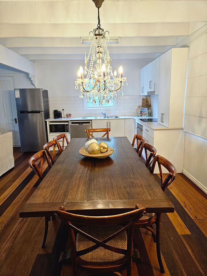 Kitchen And wooden Dining Table With Apples Kept In A Plate On Table — A Perfect Move And Clean In Welby NSW