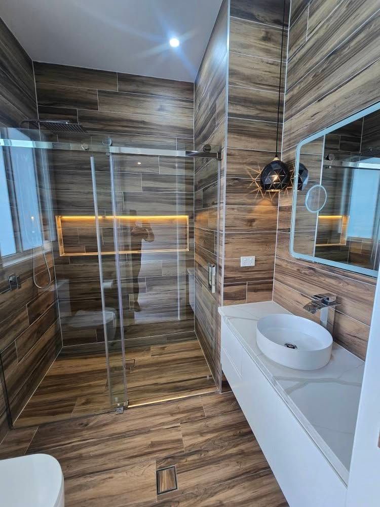 Beautiful Brown Themed Bathroom with Lights on Ceiling, Bathtub and Bathroom Sink — A Perfect Move And Clean In Moss Vale NSW