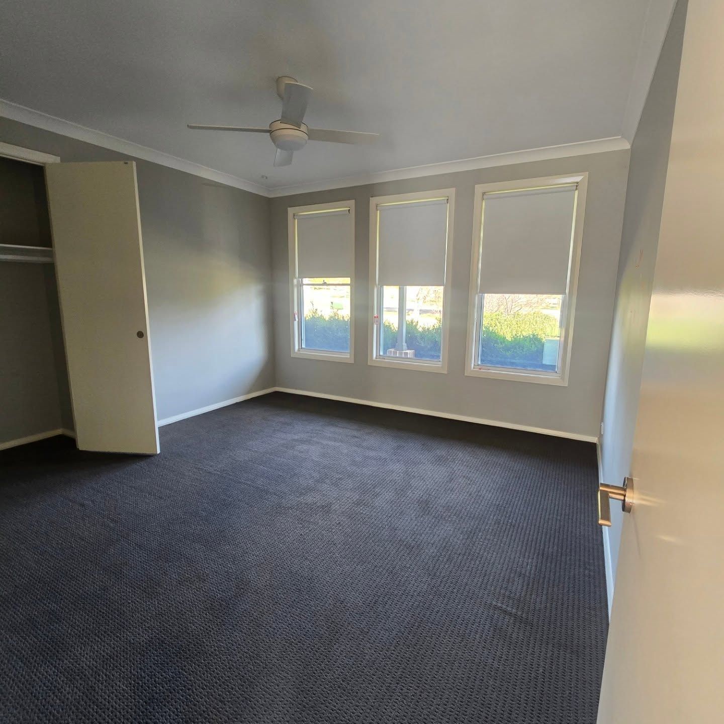 Wooden Floor House with White Walls and Two Lamps on Right side which are either side of the Door  — A Perfect Move And Clean In Bowral NSW