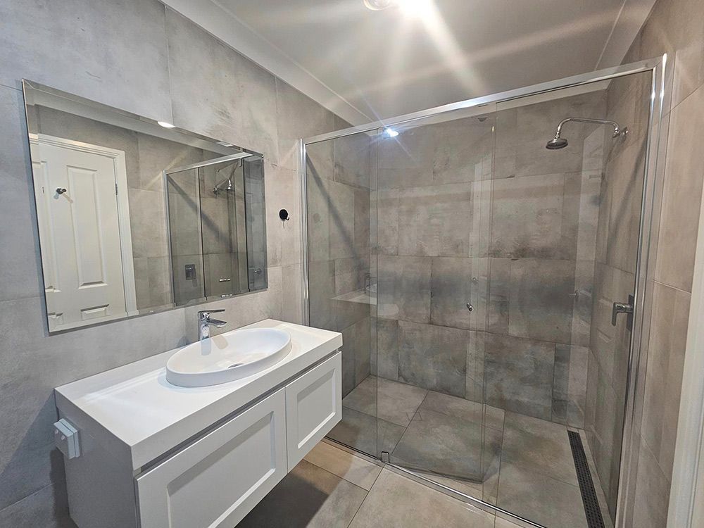 Bathroom with Shower room, mirrors and Cabinets — A Perfect Move And Clean In Welby NSW