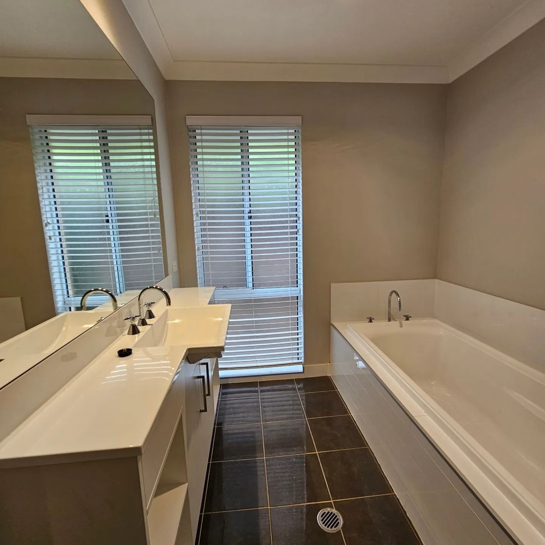 Bathroom with Big Bathtub and Bathroom sink with Big Mirror on it — A Perfect Move And Clean In Mittagong NSW