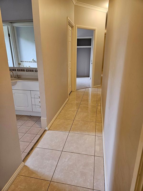 Hallway to the Bedroom and Bathroom Having a Kitchen on Left side — A Perfect Move And Clean In Mittagong NSW