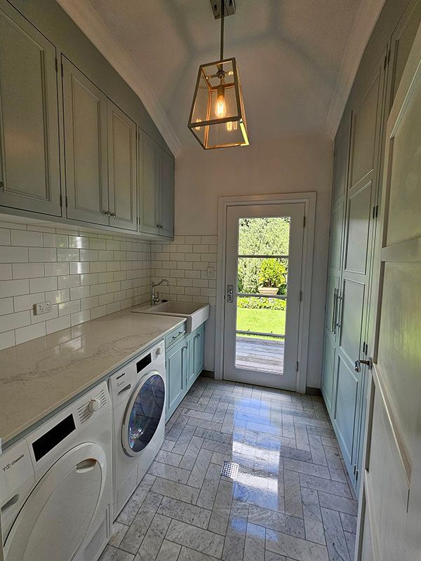 Laundry area Cleaning with Washing Machine, Cabinets and open lights — A Perfect Move And Clean In Welby NSW