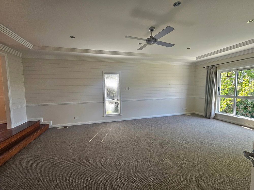 New Clean Living Room With Carpet, Ceiling Fan And Open Curtains — A Perfect Move And Clean In Welby NSW