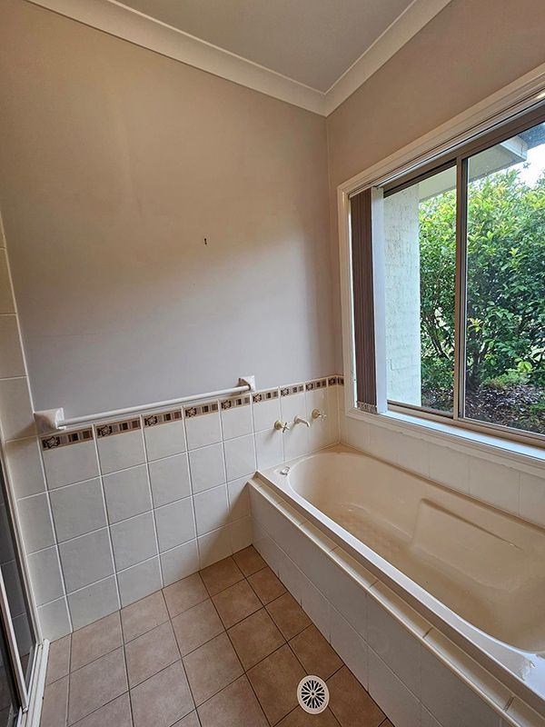 Clean Shower Room, Window with Open Curtains and Empty Bathtub — A Perfect Move And Clean In Moss Vale NSW