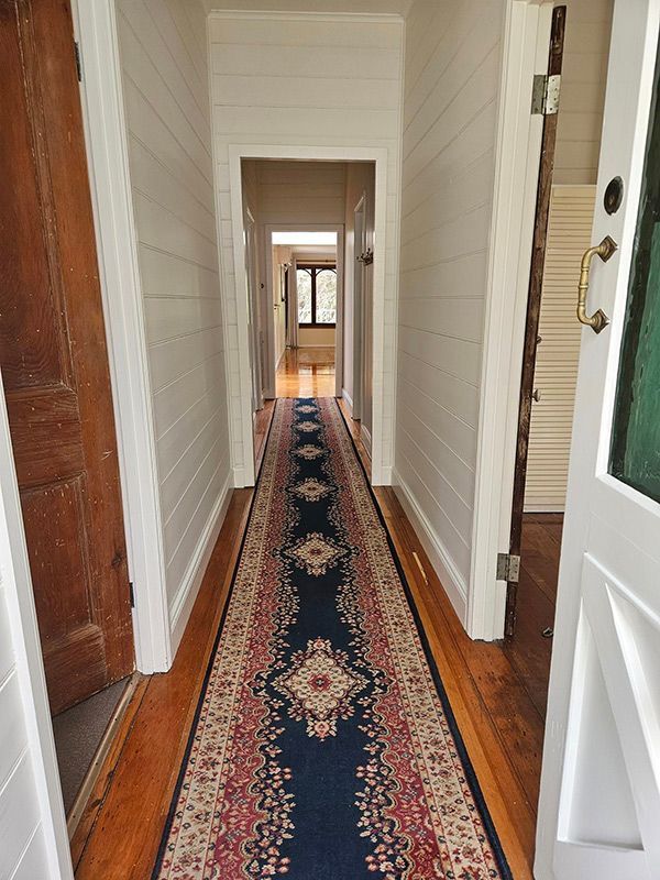 Clean Hallway with Wooden Floor and Carpet with Design — A Perfect Move And Clean In Moss Vale NSW