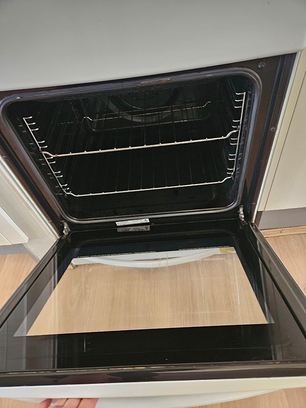 Clean Opened Oven with Black Interior and Two Trays — A Perfect Move And Clean In Moss Vale NSW