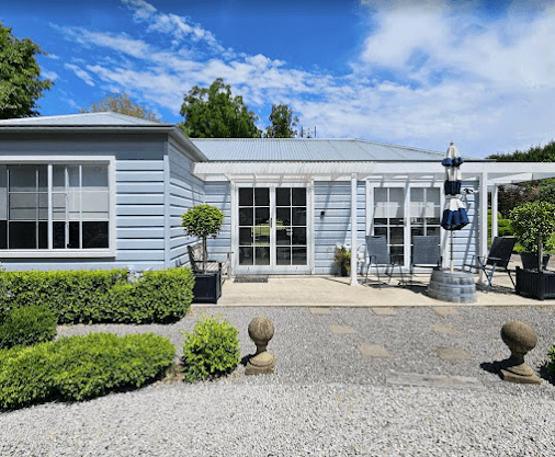 A Small House with A Patio and Umbrella in Front of It — A Perfect Move And Clean In Welby NSW