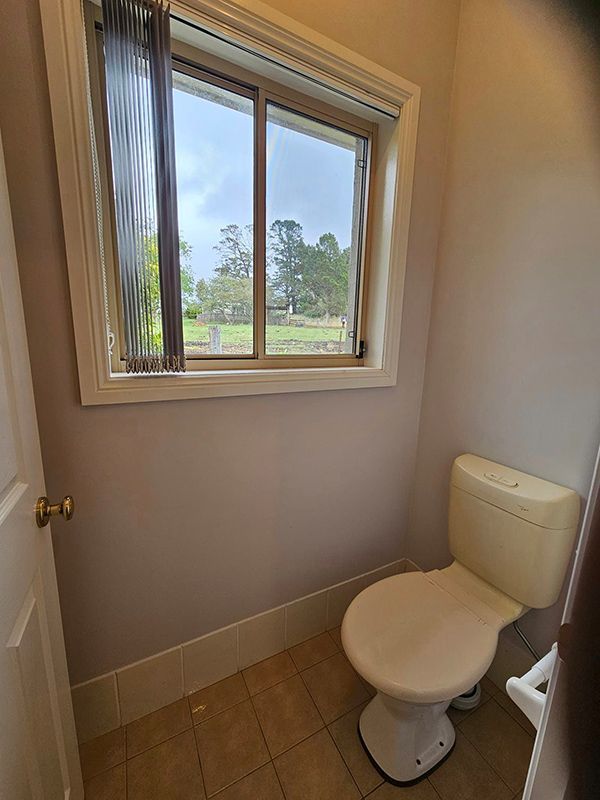 Small Washroom with Toilet Seat and Bowl Lid Closed — A Perfect Move And Clean In Mittagong NSW
