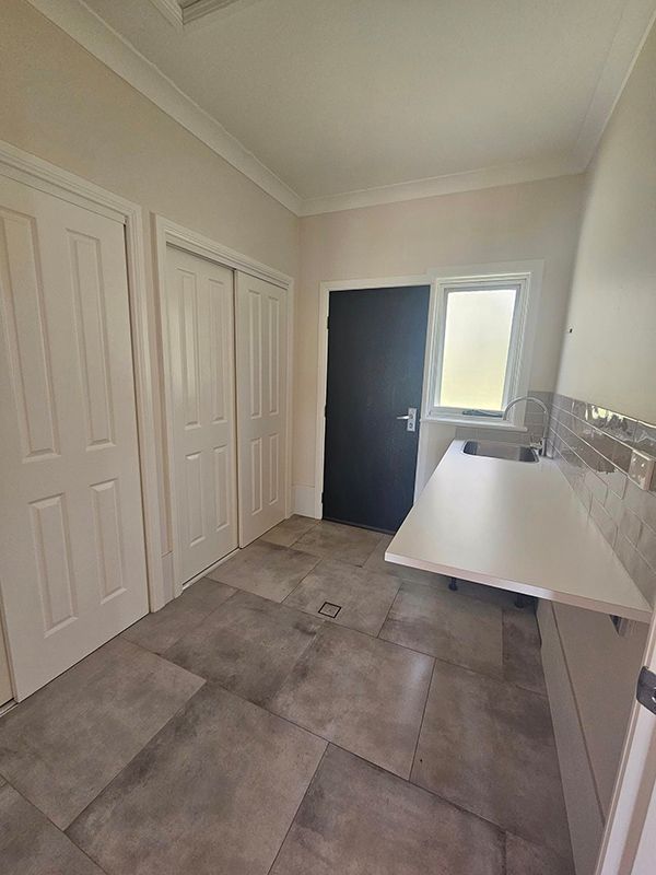Laundry with Three Closed Doors and One Black Door — A Perfect Move And Clean In Bowral NSW