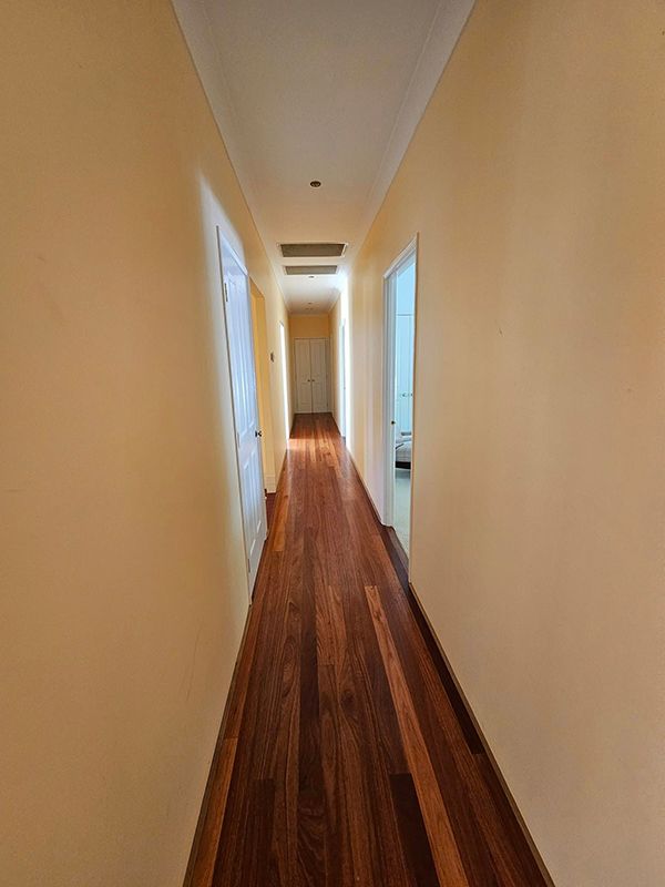 Wooden Hallway with Cream Colour Walls and Two Doors on either side — A Perfect Move And Clean In Moss Vale NSW