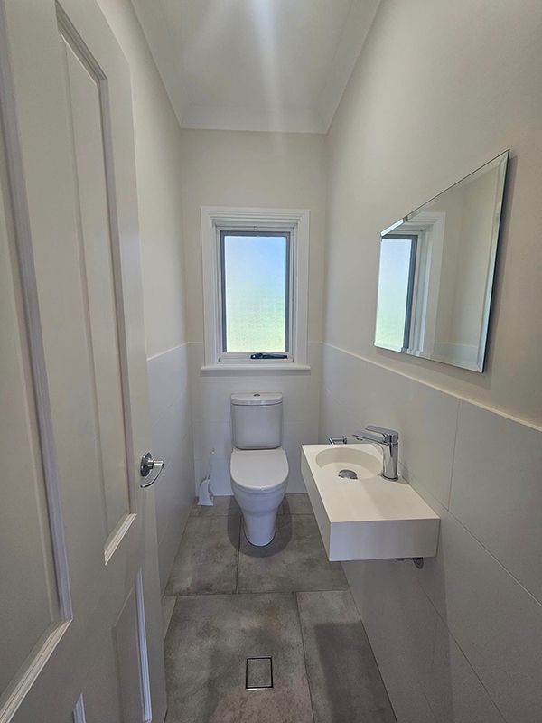 Bathroom with Sink on Right side, Toilet Seat and Small Window above it — A Perfect Move And Clean In Moss Vale NSW
