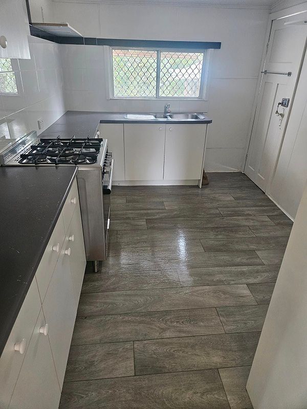 Empty Kitchen with Black Marble and White Doors — A Perfect Move And Clean In Bowral NSW