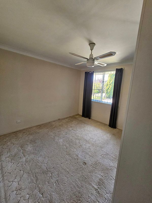 Room with Carpet, Ceiling Fan and Window with Black Open Curtains — A Perfect Move And Clean In Moss Vale NSW