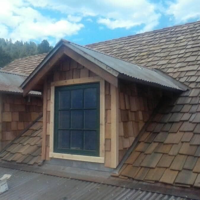 A roof with shingles and a window on it