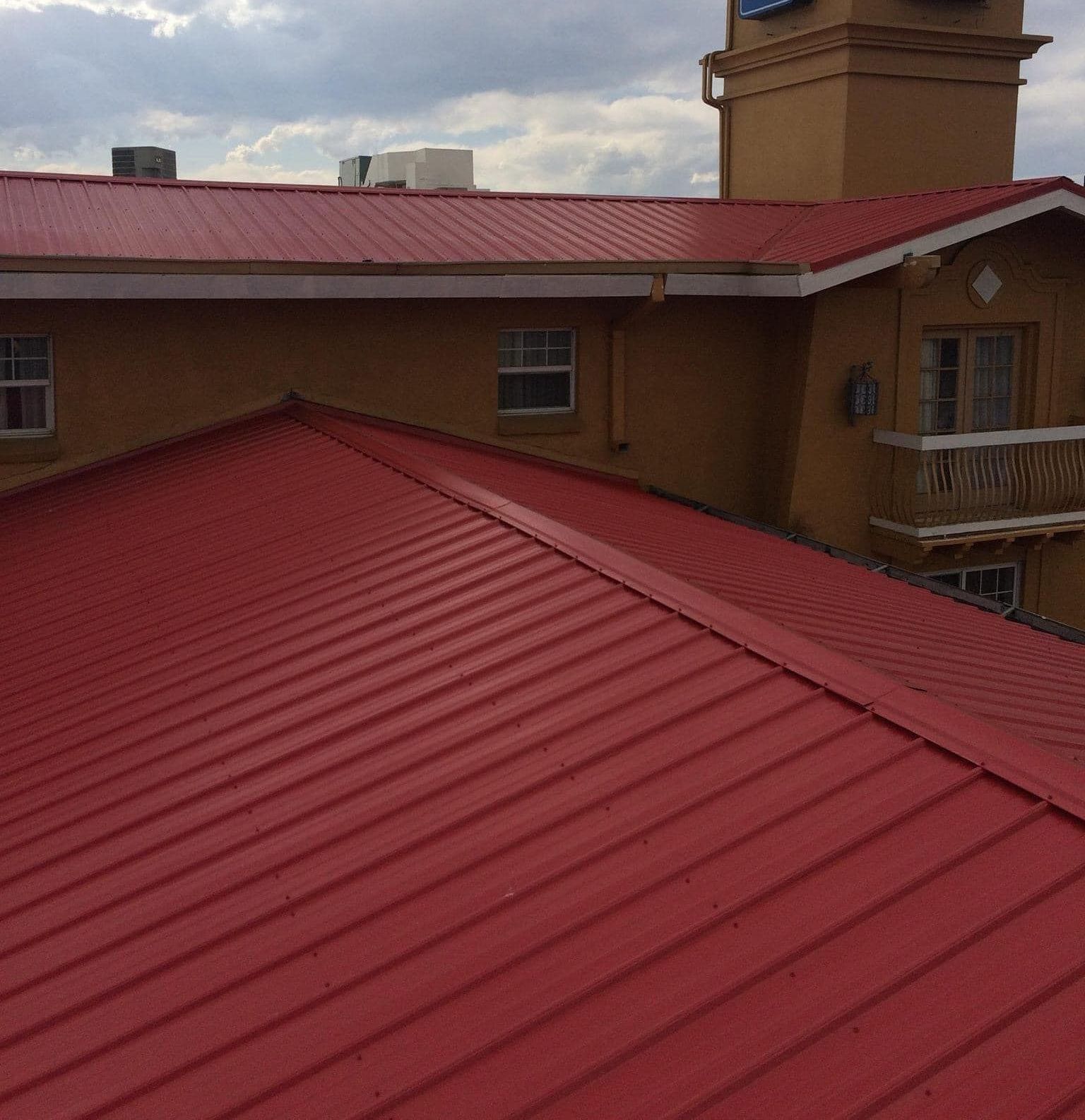 An aerial view of a house under construction with a metal roof.