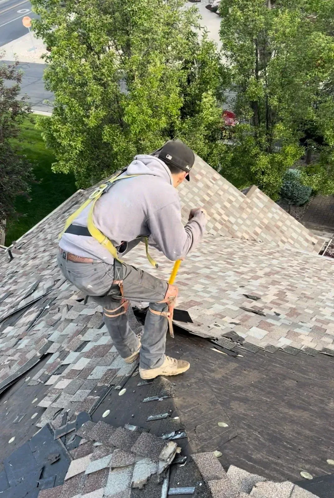 A man is working on the roof of a house.