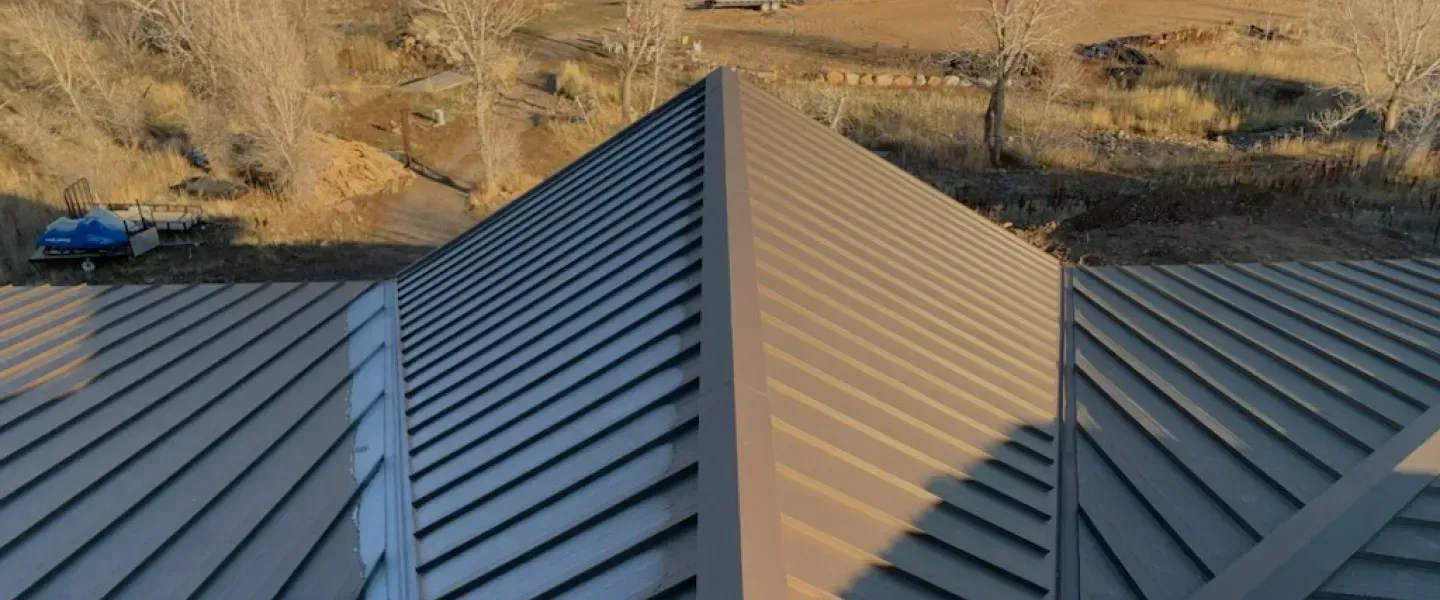An aerial view of a house with a metal roof.