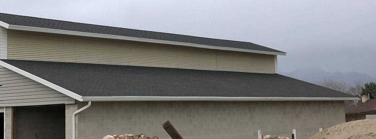 A house with a black roof and a white trim