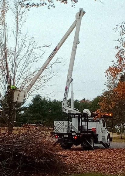 A white truck with a crane on the back of it