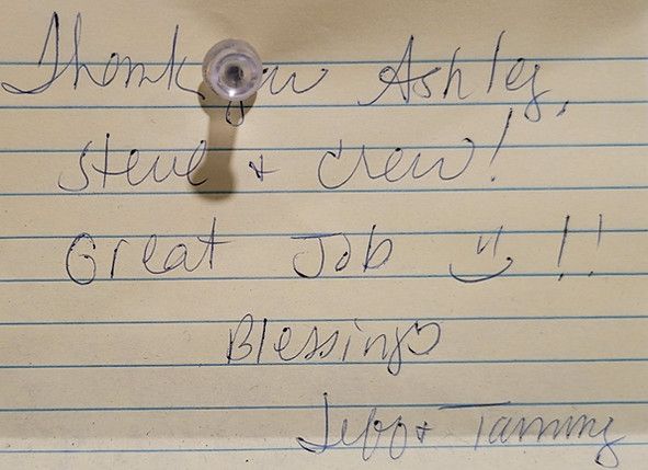 A thank you note is written on a piece of paper