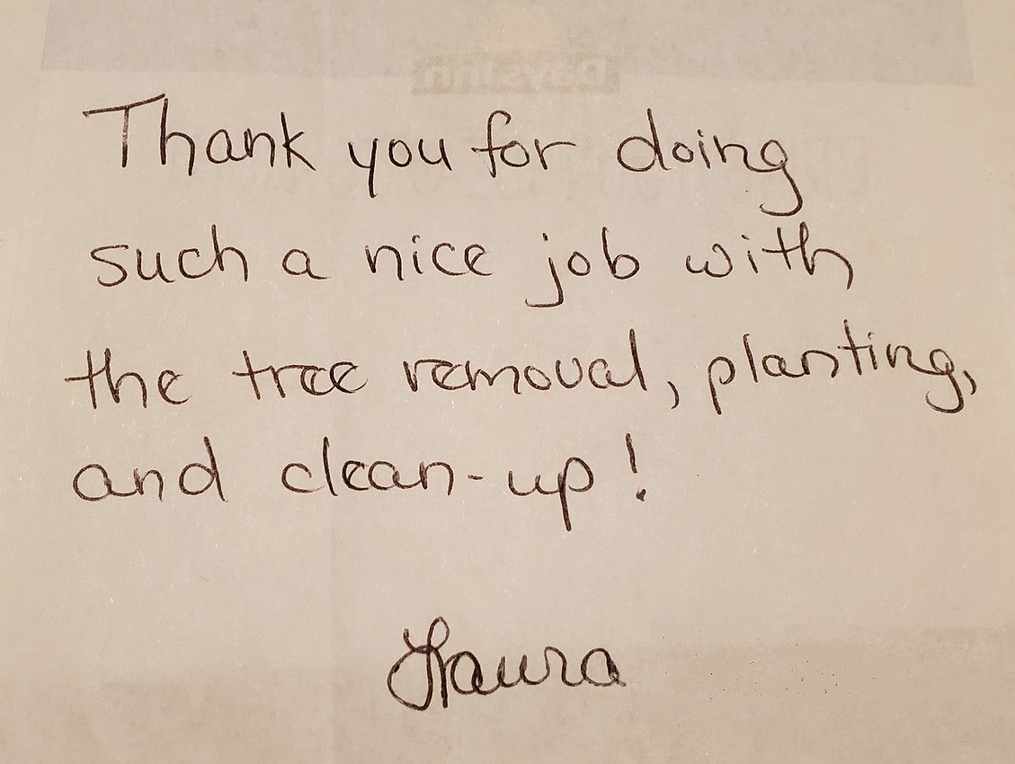 A handwritten note that says thank you for doing such a nice job with the tree removal