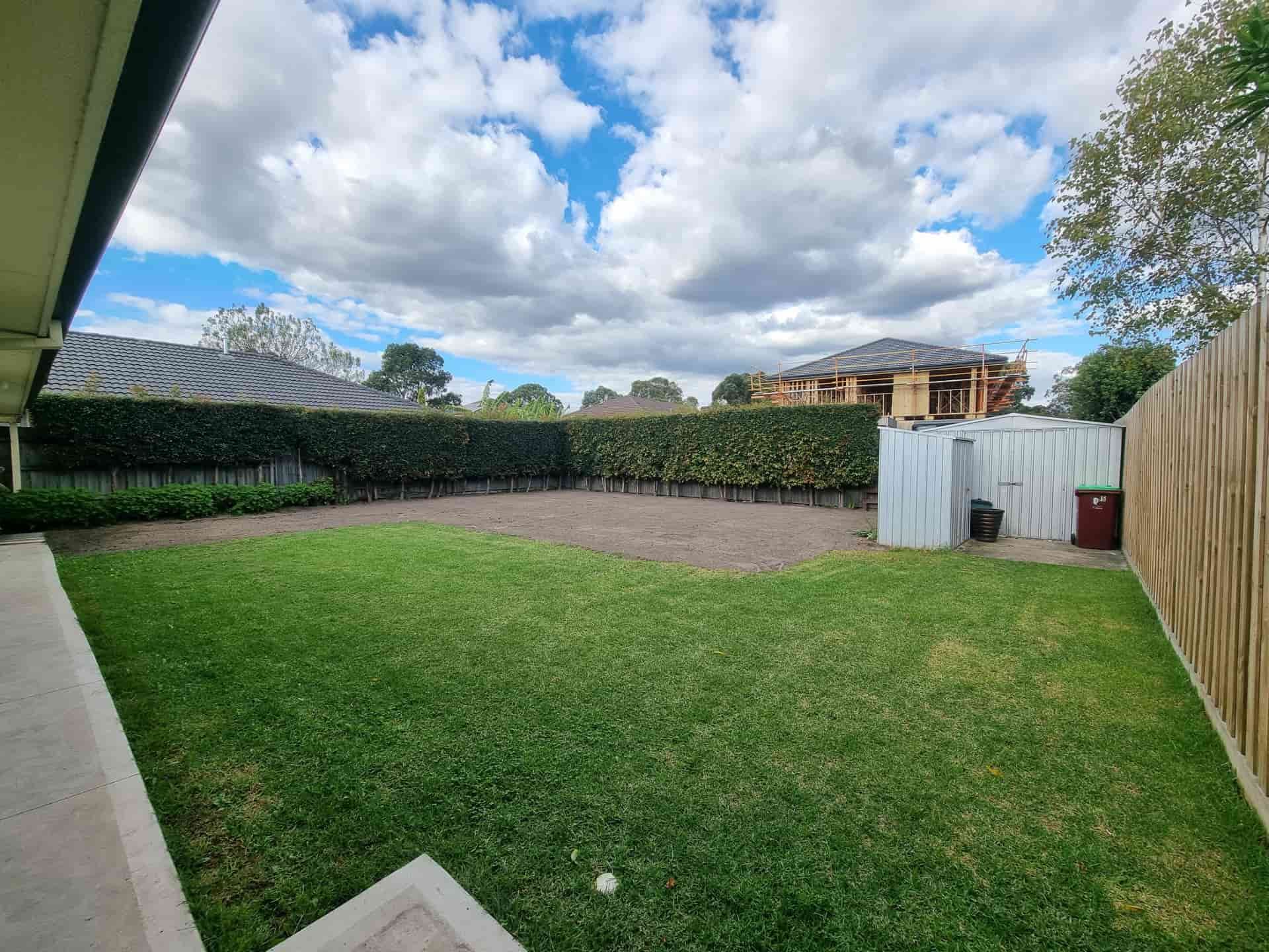 A Backyard With Green Grass, a Hedge, and a Cloudy Sky — All Over Pool Removals in Glen Waverley, VIC