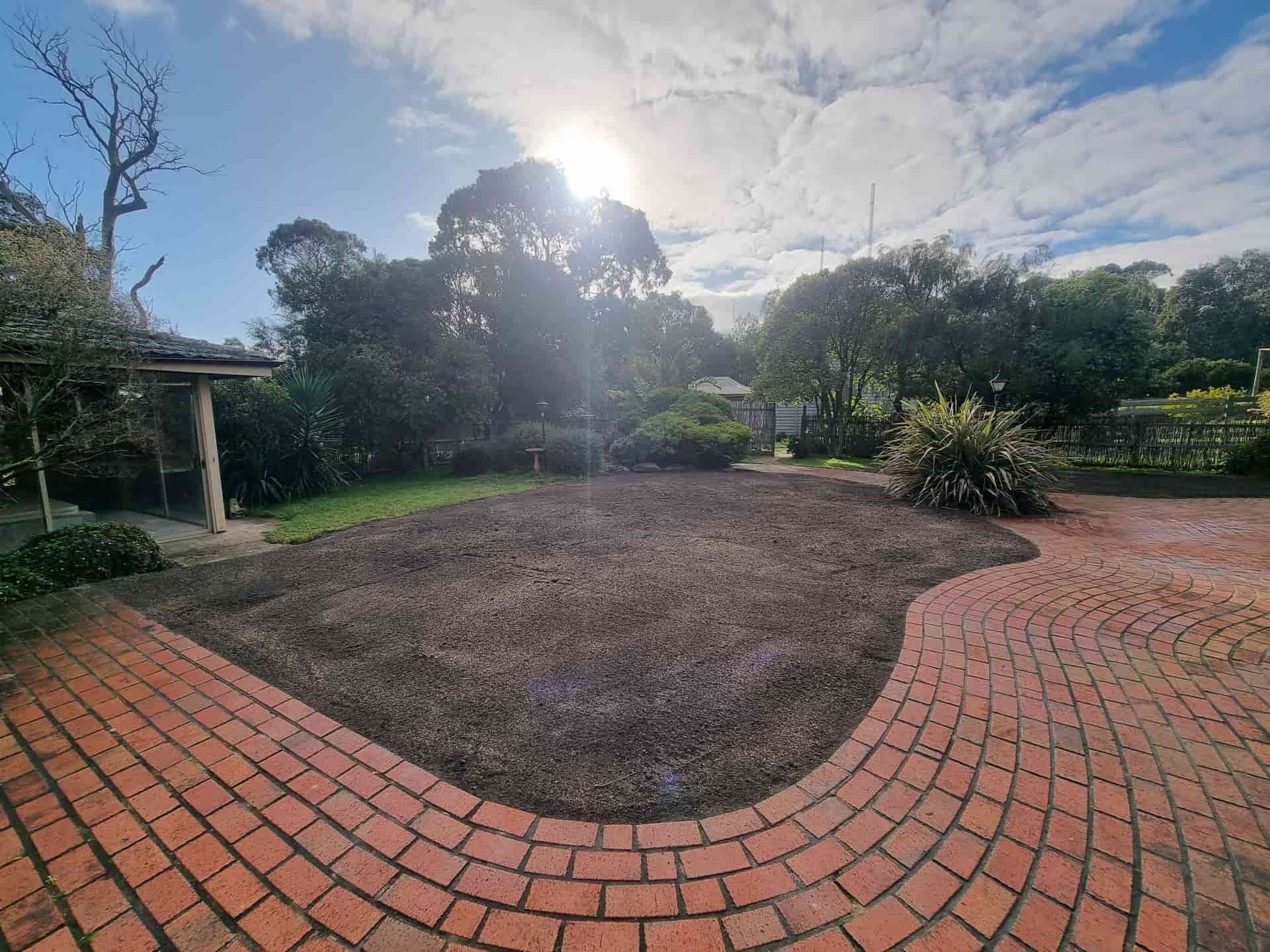 A Sunny Backyard With a Brick Patio, Mulched Area, and Trees — All Over Pool Removals in Doncaster, VIC