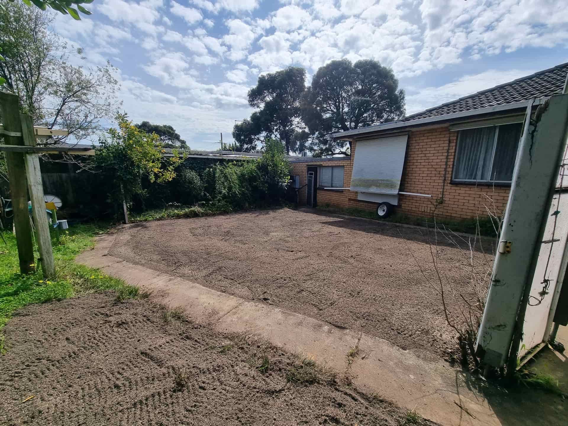Backyard With Bare Soil, a Brick House, and a Partly Cloudy Sky — All Over Pool Removals in Upwey, VIC
