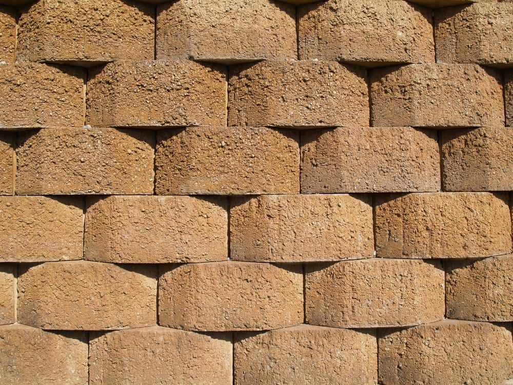 Tan, Interlocking Concrete Blocks Forming a Textured Retaining Wall — All Over Pool Removals in Upwey, VIC