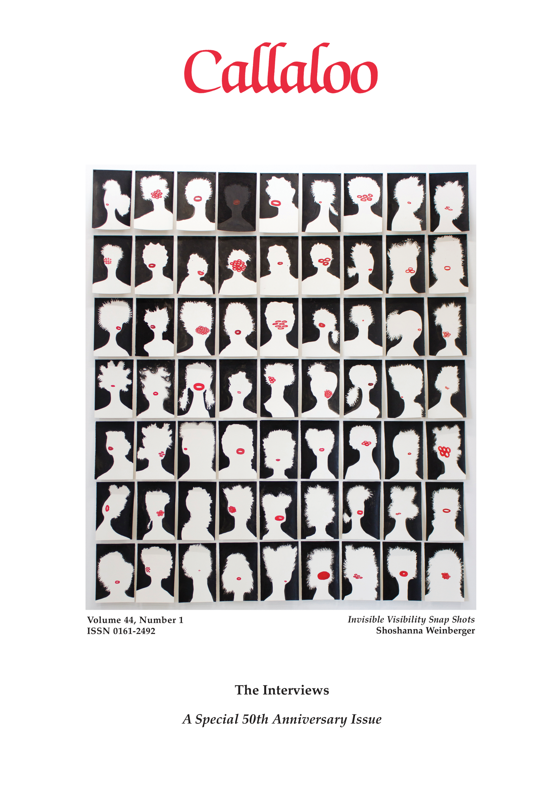 A black and white photo of a man in a suit standing in front of a crowd.